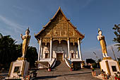 Vientiane, Laos - Pha That Luang, the elegant structure, Wat That Luang Neua, with a very ornate front faade fronted by two tall standing Buddha statues.